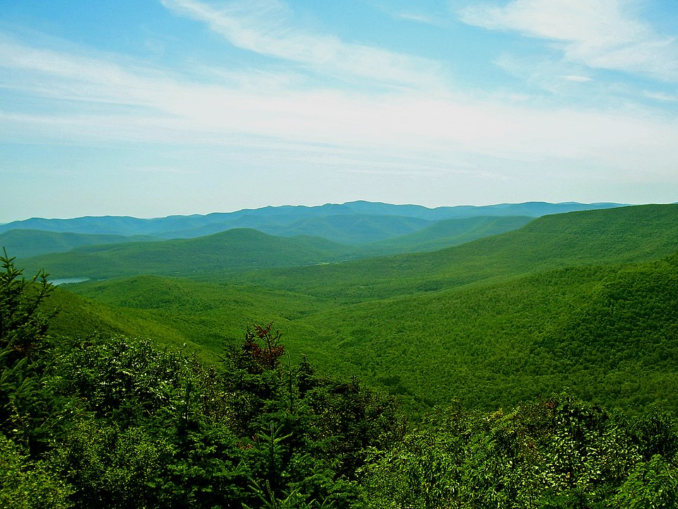 Scenic Catskills mountain road winding through autumn foliage with Ashokan Reservoir views