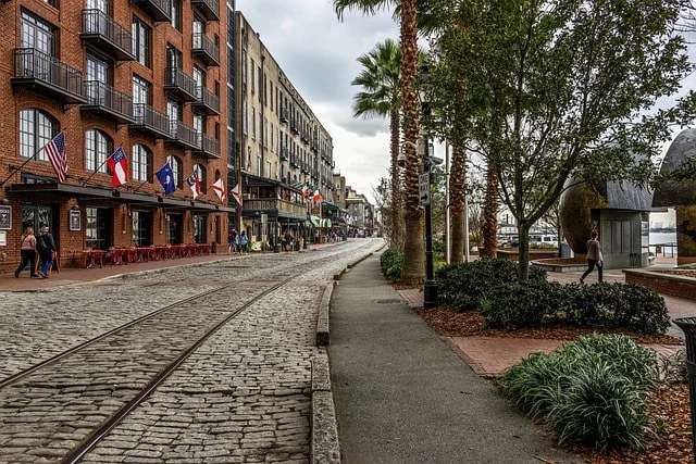 Savannah waterfront along the Savannah River with historic buildings and riverboat
